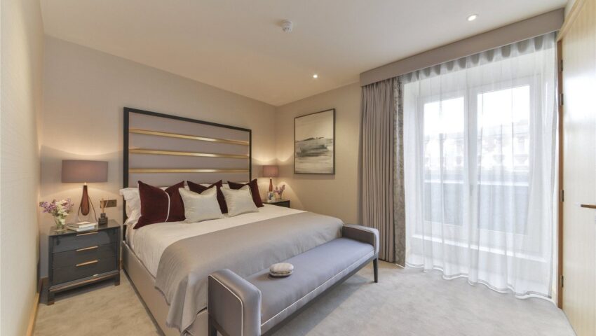 Cozy and elegant bedroom with large windows, ample storage, and a calm, restful atmosphere.